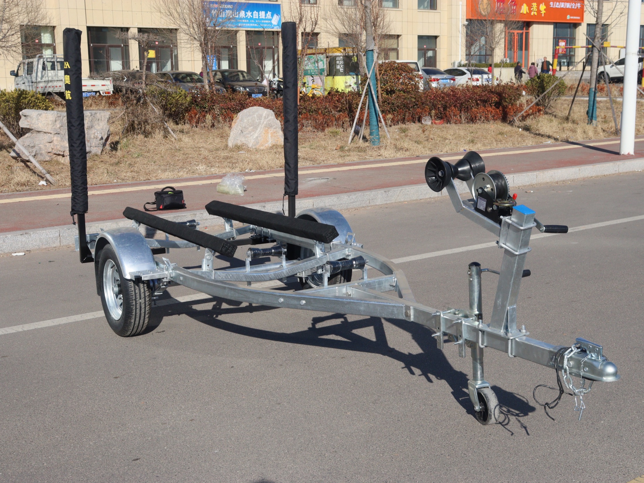 Natural galvanized boat trailer on the road